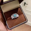 Détail d'une bague vintage avec pierre bleu ciel, perles et zircons dans un écrin - Style perle Larimar