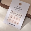Close-up of geometric purple rhinestone nail decorations on product packaging card - MJ-025 Silver Foil Style