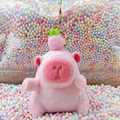 Pink plush capybara keychain with pig hat and peach decoration on a colorful background - Pink Peach Style + Gold Clip