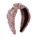 Dettaglio di cerchietto in tweed rosa con nodo, strass scintillanti e perle bianche - Rosa