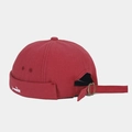 Detail of adjustable metal buckle and fish embroidery on burgundy docker cap - Burgundy