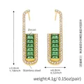 Detail showing gold earrings with green emerald-cut zircon and white side stones - Green Zircon Earrings / Green