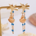 Macro shot of gold ocean-style earrings featuring starfish studs and blue beaded tassels - Gold (0743)