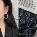 Detailed view of large silver hoop earrings showing 4cm diameter and polished metal finish - 4cm / Minimalist Hoop / Silver