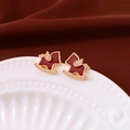 Close-up of 18K gold plated rocking horse stud earrings with red enamel and crystals - Rocking Horse Stud Earrings (Silver Earring Post) / Gold-Red