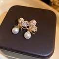 Detail of gold bow earrings with sparkling cubic zirconia and elegant white pearls - Gold Bow Heart Pearl - Real Gold Plated (25# Silver Needle)