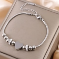 Detail of a silver snake chain bracelet with heart charms on a luxury jewelry box - Silver B-252S (Heart/Rhinestone)