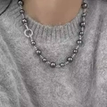 Elegant French vintage black pearl necklace with a circular rhinestone clasp on a sweater - Round Screw Zircon Style (8-10mm) / Faux Pearl Zircon Necklace