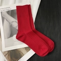 Chic ribbed knit crew socks in bold red color shown on a minimalist magazine background - Short Wine Red