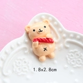 Macro shot of 1.8x2.8cm miniature resin bear charm on white relief ceramic tray - Hot Dog Bear Bread