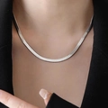 Polished silver flat snake chain necklace shown on a model wearing a black blazer - Length 40+5cm / Silver