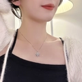 Elegant silver snowflake pendant necklace on model's neck for a dainty layered jewelry look - Snowflake Style