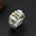 Gothic punk silver skull fist ring with gold skull accent for men in a 45-degree view - Two-tone Skull Fist Ring