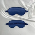 Navy blue satin silk sleep masks with elastic headbands shown on soft white fabric - Navy Blue