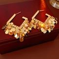 Elegant gold plated square hoop earrings with layered tassel charms on dark wood - Gold