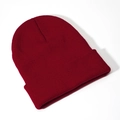 Detail view of burgundy acrylic knit beanie showing fine ribbed texture and folded cuff - Burgundy