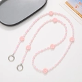 Detailed view of pink acrylic floral beaded crossbody phone strap with silver metal rings - Pink