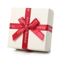 Close-up of cream textured jewelry gift box with red silk ribbon and elegant bow detail - Premium Gift Box
