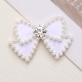 Elegant white bow charm accessory with pearl edges and sparkling center rhinestone - Silver Base White