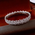 Macro shot of silver paved cubic zirconia bangle inside a red velvet jewelry box - Silver