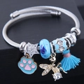 Adjustable angel wing charm bracelet with blue glass beads and cat paw pendant detail - Blue