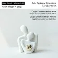 Modern minimalist white ceramic couple sculpture with a polished golden heart accent - B495-0003 Mini Platinum