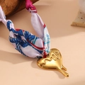 Detailed macro of golden fluid heart pendant with colorful floral silk scarf chain - Scarf Heart Necklace (Random Scarf Color)