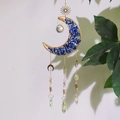 Detail of crescent moon crystal catcher with blue stones and a faceted prism ball - Lapis Lazuli