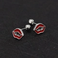 Close-up of red lip shaped titanium steel stud earrings with secure screw ball backings - Lip / Steel