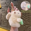 Beige Capybara plush keychain with pull-string flapping wings and a green swimming ring - Pull String Ball Capybara Light Brown