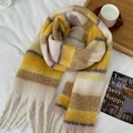 Colorful striped scarf with tassels in yellow and brown plaid design on white sheets - Yellow