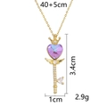 Gold heart crown key necklace with purple crystal and wings on a white background - Crown Wing Key