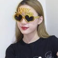 Golden heart-shaped Happy New Year party glasses shown on a model for festive celebrations - Gold Electroplated Heart New Year Glasses