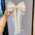 Handheld cream oversized layered tulle bow hair clip with ribbons and pearl accents - Off White