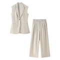 Beige damespak met een vest met revers en een bijpassende broek met wijde pijpen - XS / Abrikoos