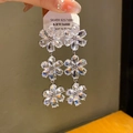 Elegant 925 sterling silver drop earrings featuring three linked zircon flower charms - Silver Zirconia Flower Tassel Style