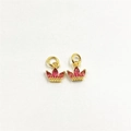 Close-up of gold crown pendant with pink zircon gems and polished metal finish - Rose Red Zirconia