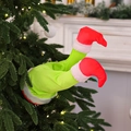Furry green Grinch-style elf legs with red shoes inserted into a decorated Christmas tree - Grinch