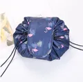 Detail of drawstring makeup bag with flamingo print and secure flap closure design - Navy Flamingo