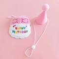 Close-up of pink felt birthday hat and embroidered pet bib on a soft pink background - Pink Birthday Set