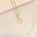 Polished gold stainless steel letter O pendant necklace with dotted texture detail - Letter O