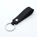 Minimalist black PU leather keychain with silver metal ring and rivet on white background - Black & Silver
