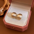 Macro detail of matte gold geometric stud earrings placed in a pink velvet jewelry box - Gold C-shaped Bean (4#)