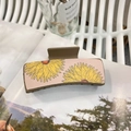 Detail shot of a square hair claw clip featuring yellow sunflower patterns on a pink background - Approx 10.5cm / Brown - Large Yellow Sunflower
