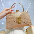 Champagne gold evening clutch with pleated fabric and sparkling rhinestone ring handle - Champagne