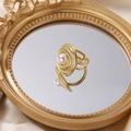 Adjustable golden pearl ring with spiral texture design on elegant silk background - Ring