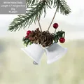 White Christmas bell ornament with natural pine cone and red berries hanging on a tree - White Double Bells