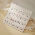 Set de 12 paires de boucles d'oreilles en alliage doré avec perles et motifs de coeurs - E1951-1
