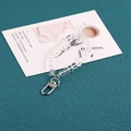 Minimalist clear acrylic bead keychain with silver lobster clasp on a green background - Transparent Crystal Glass Style