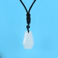 Macro view of white translucent geometric stone pendant with black woven rope - White Crystal